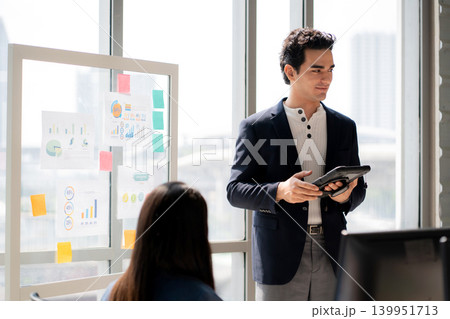 Businessman giving presentation on glass board. 139951713