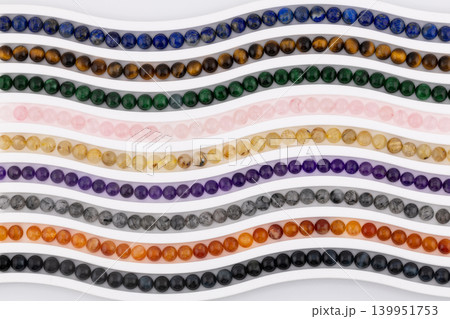 Colorful gemstone bead strands arranged in vertical curved rows Colorful gemstone bead strands arranged in vertical curved rows 139951753