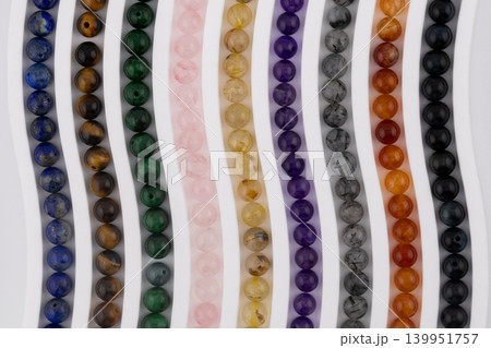 Macro gemstone bead strands arranged in curved pattern 139951757