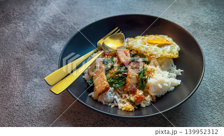 Rice topped with crispy pork belly with Thai basil and fried egg Rice topped with crispy pork belly with Thai basil and fried egg 139952312