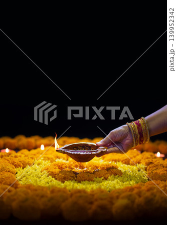 Clay diya lamps lit during diwali celebration, Diwali, or Deepavali, is India's biggest and most important holiday. 139952342