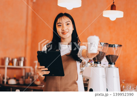 Young woman at barista school learning how to make espresso coffee. 139952390