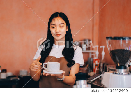 Young woman at barista school learning how to make espresso coffee. 139952400