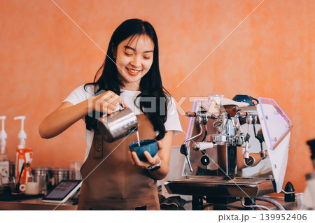 Young woman at barista school learning how to make espresso coffee. Young woman at barista school learning how to make espresso coffee. 139952406