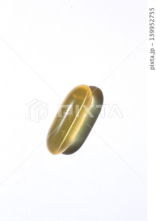 It is a pill placed on a white background. It is a pill placed on a white background. 139952755