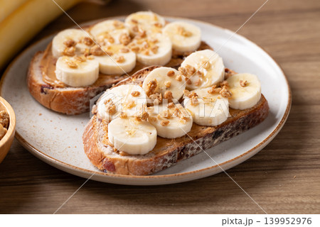 Cranberry sourdough bread with peanut butter, banana, granola and honey Cranberry sourdough bread with peanut butter, banana, granola and honey 139952976