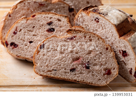 Sliced cranberry sourdough bread on cutting wooden background, Homemade bakery and healthy eating 139953031