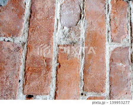 Weathered red brick wall texture. Weathered red brick wall texture. 139953277