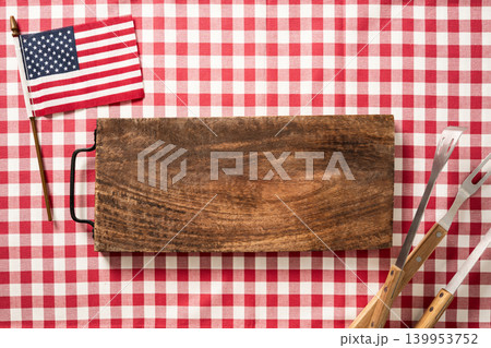 BBQ board with USA flag and grill tools independence day concept BBQ board with USA flag and grill tools independence day concept 139953752