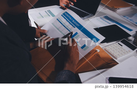 Professional photo of a person's hands reviewing a contract or legal document on a desk, for concepts of business, finance, and legal affairs Professional photo of a person's hands reviewing a contract or legal document on a desk, for concepts of business, finance, and legal affairs 139954618