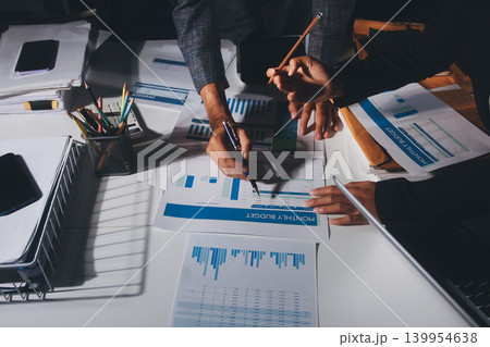 Professional photo of a person's hands reviewing a contract or legal document on a desk, for concepts of business, finance, and legal affairs 139954638