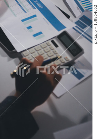Professional photo of a person's hands reviewing a contract or legal document on a desk, for concepts of business, finance, and legal affairs Professional photo of a person's hands reviewing a contract or legal document on a desk, for concepts of business, finance, and legal affairs 139954652
