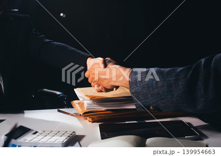 Professional photo of a person's hands reviewing a contract or legal document on a desk, for concepts of business, finance, and legal affairs Professional photo of a person's hands reviewing a contract or legal document on a desk, for concepts of business, finance, and legal affairs 139954663