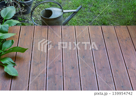Wooden Terrace Planks with Vintage Watering Can 139954742