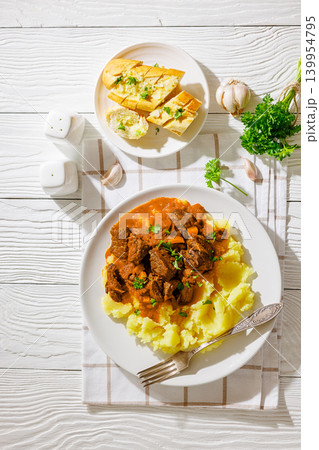slow cooked beef meat stew served with mashed potatoes 139954795