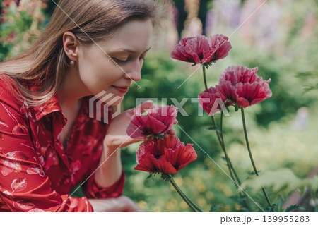 Portrait of young beautiful woman with poppies in the garden Portrait of young beautiful woman with poppies in the garden 139955283