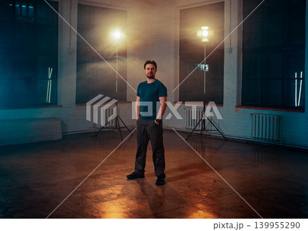 Young man director posing in photo studio with constant light Young man director posing in photo studio with constant light 139955290