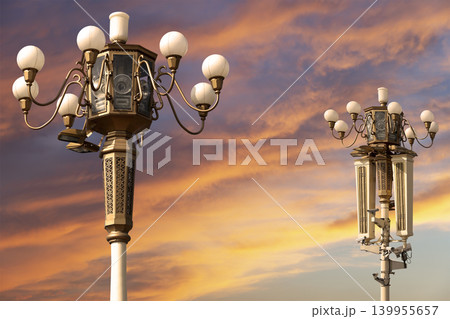 Street lamp on Tiananmen Square in Beijing, China (against the sunset), with propaganda or public announcement speakers Street lamp on Tiananmen Square in Beijing, China (against the sunset), with propaganda or public announcement speakers 139955657