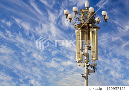 Street lamp on Tiananmen Square in Beijing, China (against the background of a beautiful sky with clouds), with propaganda or public announcement speakers Street lamp on Tiananmen Square in Beijing, China (against the background of a beautiful sky with clouds), with propaganda or public announcement speakers 139957123