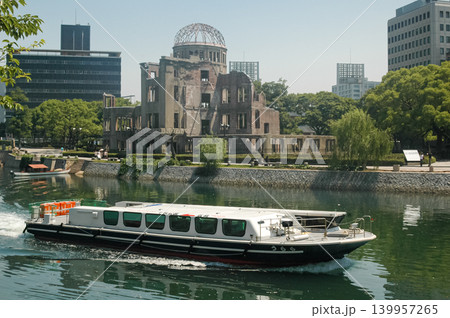 A ship crosses in front of the church that resisted the atomic bombing of hiroshima, Nuestra Senora de la Asuncion A ship crosses in front of the church that resisted the atomic bombing of hiroshima, Nuestra Senora de la Asuncion 139957265