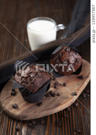 Chocolate Cake and Glass of Milk on Wooden Table. 139957867