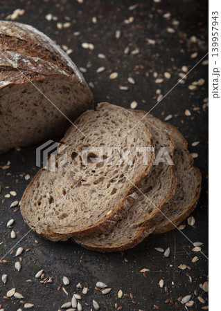 Sliced Sunflower Seed Bread Presentation. Artisan Sunflower Seed Bread on Rustic Surface. Sliced Sunflower Seed Bread Presentation. Artisan Sunflower Seed Bread on Rustic Surface. 139957943