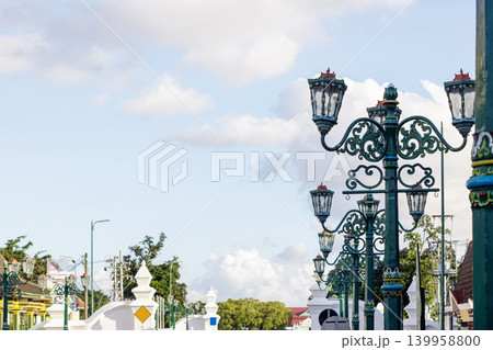 Street lamps with ornate details against a blue sky. Urban City at Daytime. Historical Street. Classic Architecture. High quality photo Street lamps with ornate details against a blue sky. Urban City at Daytime. Historical Street. Classic Architecture. High quality photo 139958800