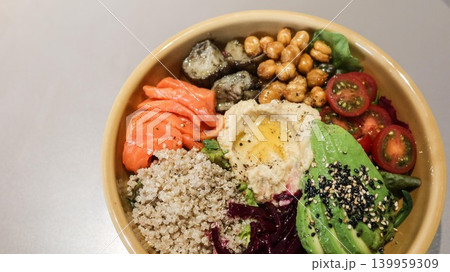 close up of healthy meal for diet colourful grain salad bowl with avocado, salmon, carrot slice, beetroot, chickpeas, quinoa, and fresh vegetables for balanced meal with copy space close up of healthy meal for diet colourful grain salad bowl with avocado, salmon, carrot slice, beetroot, chickpeas, quinoa, and fresh vegetables for balanced meal with copy space 139959309