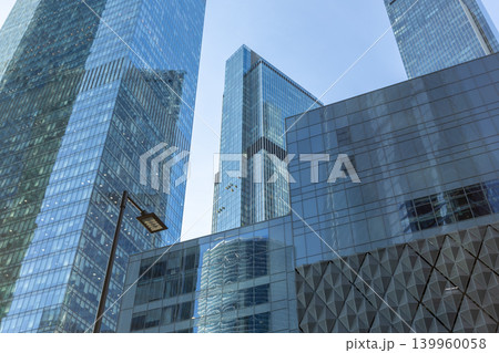 Modern glass skyscrapers on a clear day. Business center of a big city Modern glass skyscrapers on a clear day. Business center of a big city 139960058