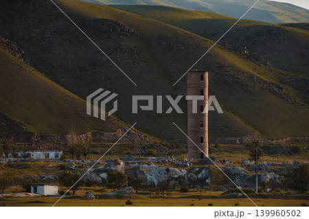 Old abandoned tower on mountains background, Kyrgyzstan Old abandoned tower on mountains background, Kyrgyzstan 139960502