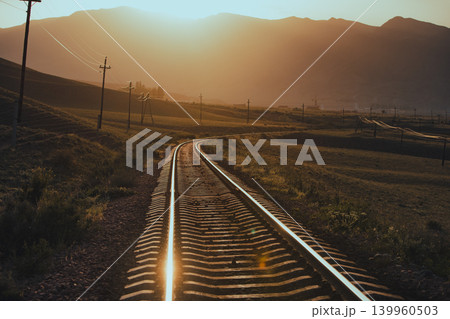 Railroad in the mountains at warm sunset light Railroad in the mountains at warm sunset light 139960503