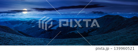 beautiful panorama of mountainous landscape at night. full moon over wide view of cloudy sky over the grassy slope of a mountain ridge. mysterious summer weather. adventure tourism in highland 139960521