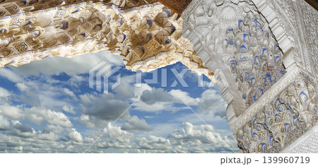 Arches in Islamic (Moorish) style (against the background of a beautiful sky with clouds) in Alhambra, Granada, Spain 139960719