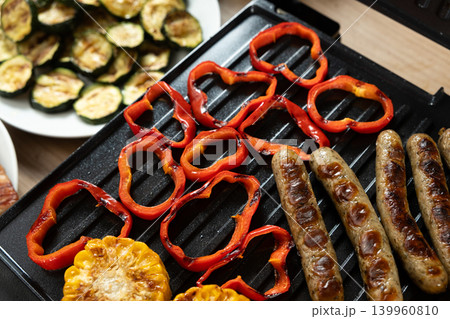 Tasty sausages and roasted vegetables with grill marks 139960810