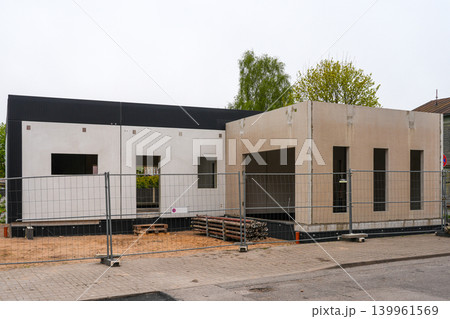 Modern modular prefab house with exposed insulation panels during residential construction phase Modern modular prefab house with exposed insulation panels during residential construction phase 139961569