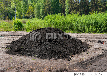 Large pile of fertile black soil on cleared farmland during agricultural site preparation work Large pile of fertile black soil on cleared farmland during agricultural site preparation work 139961578