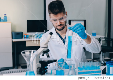 Lab technician experimenting in lab 139961624