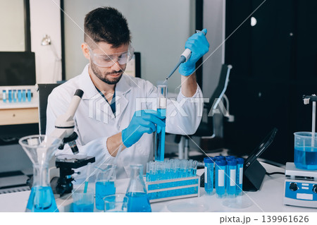 Lab technician experimenting in lab Lab technician experimenting in lab 139961626