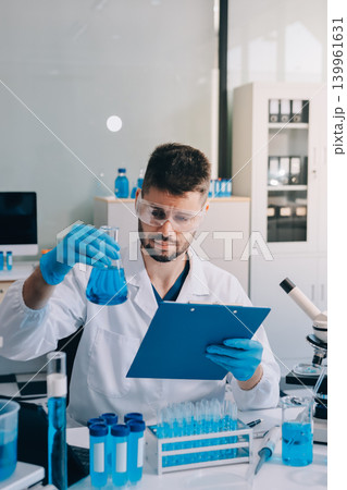 Lab technician experimenting in lab Lab technician experimenting in lab 139961631
