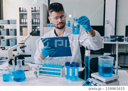 Lab technician experimenting in lab Lab technician experimenting in lab 139961633