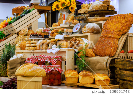 Variety of bread pastries are arranged on wooden crates at local market. Variety of bread pastries are arranged on wooden crates at local market. 139961748