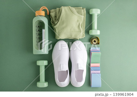 Fitness essentials planning healthy active lifestyle on green background 139961904