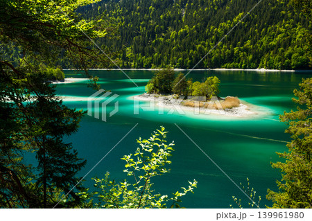 Travel landscape of Eibsee lake and island in Alps in Bavaria Germany, scenic summer nature panorama with forest Travel landscape of Eibsee lake and island in Alps in Bavaria Germany, scenic summer nature panorama with forest 139961980