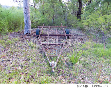 An old and rusty trailer abandoned in a forest An old and rusty trailer abandoned in a forest 139962085