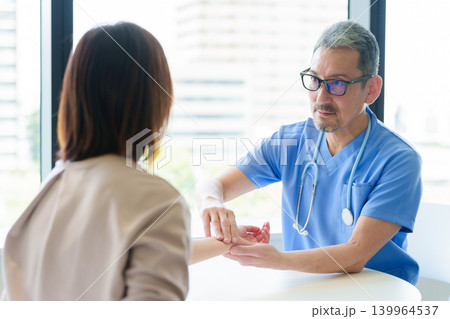 患者の脈拍を測定する医師 患者の脈拍を測定する医師 139964537