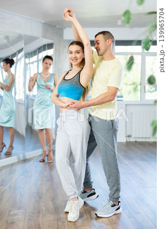 Smiling woman and man dancing bachata in choreography studio 139965704
