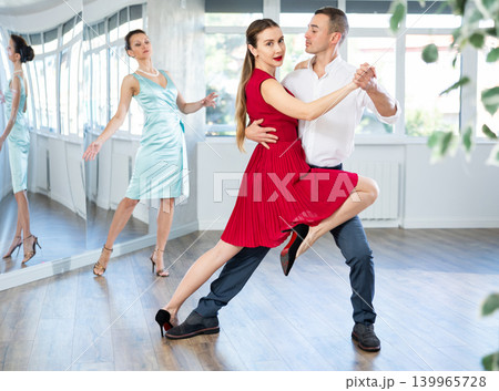 Graceful duet dancing passionate tango during dance class 139965728
