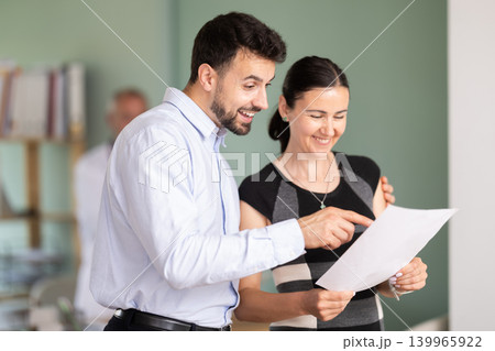 Happy spouses patients of clinic with documents experiences joy from successful outcome of treatment. 139965922