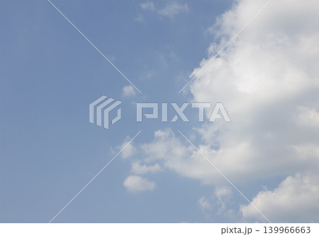 It is a blue sky and white fluffy clouds. 139966663