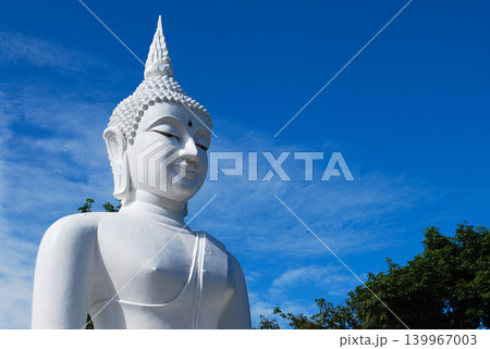 White Buddha statue with clear blue sky background in Thailand. White Buddha statue with clear blue sky background in Thailand. 139967003